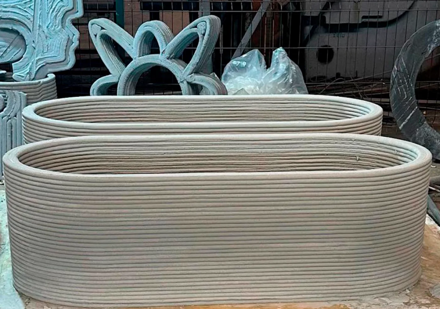 Two repeatable oval concrete components with visible printed layers